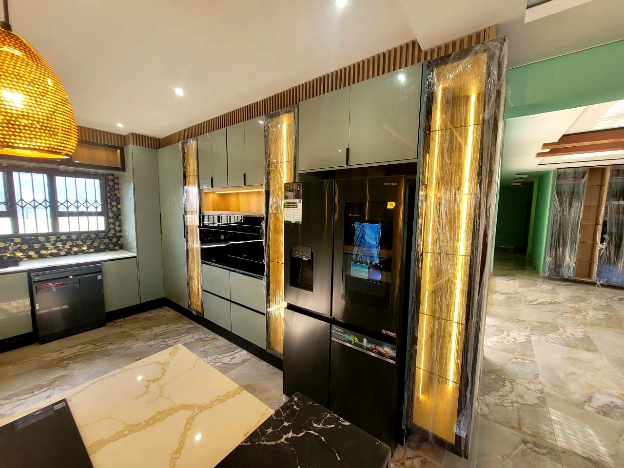 Luxury kitchen with black glass finishes and premium cabinetry