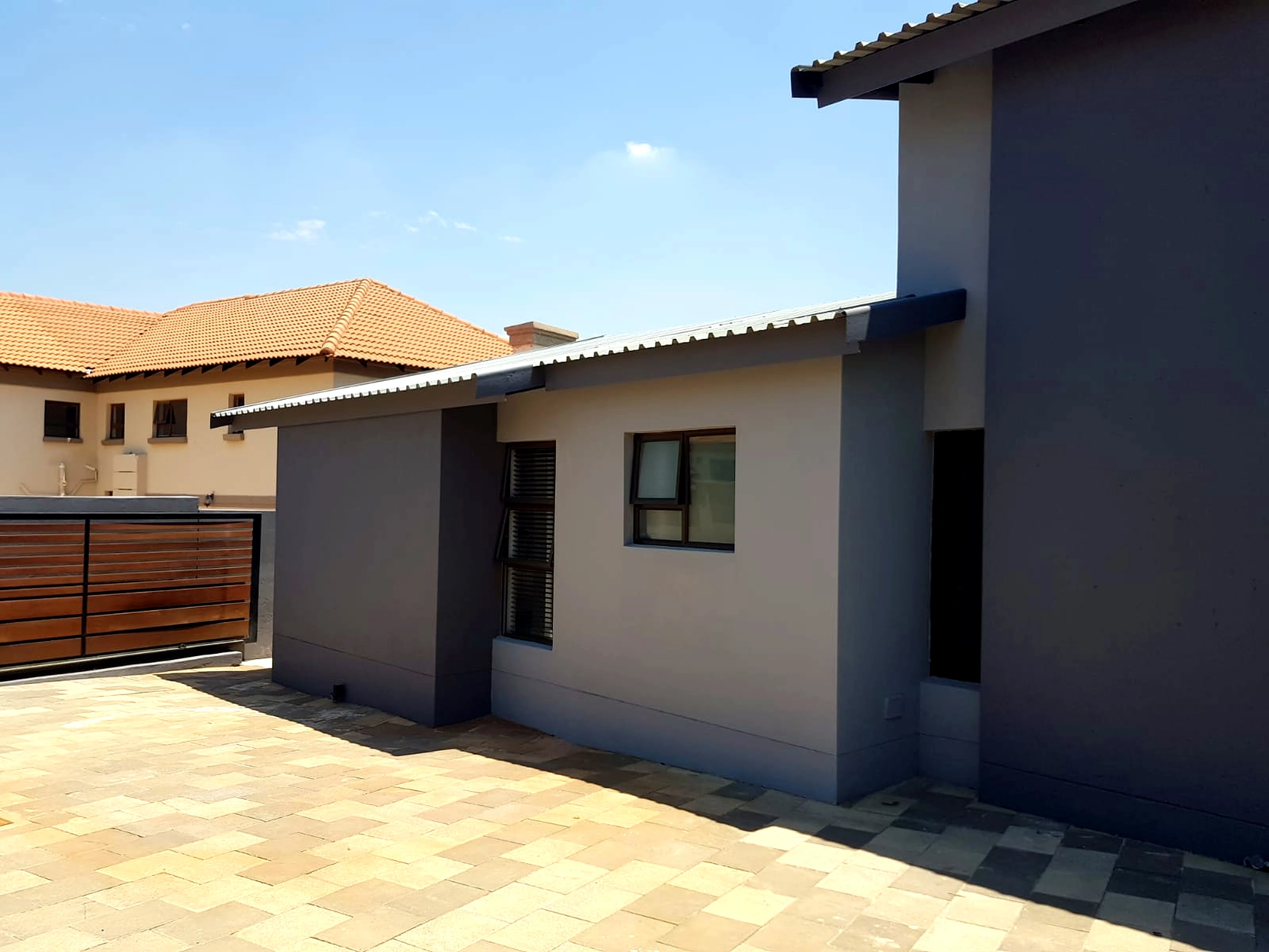 New build house side yard exterior with completed finishes