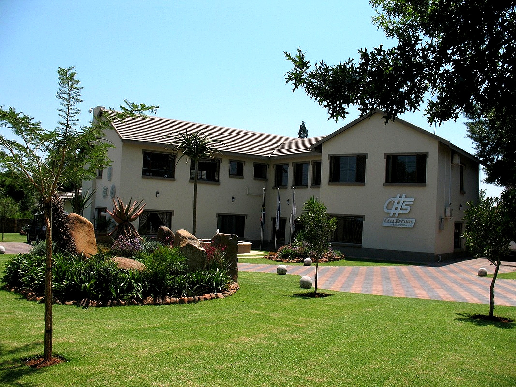 Commercial office building constructed by contractors with landscaped garden and modern exterior design.